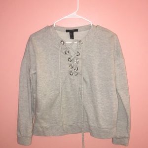 Grey cropped sweater with zig zag opening
